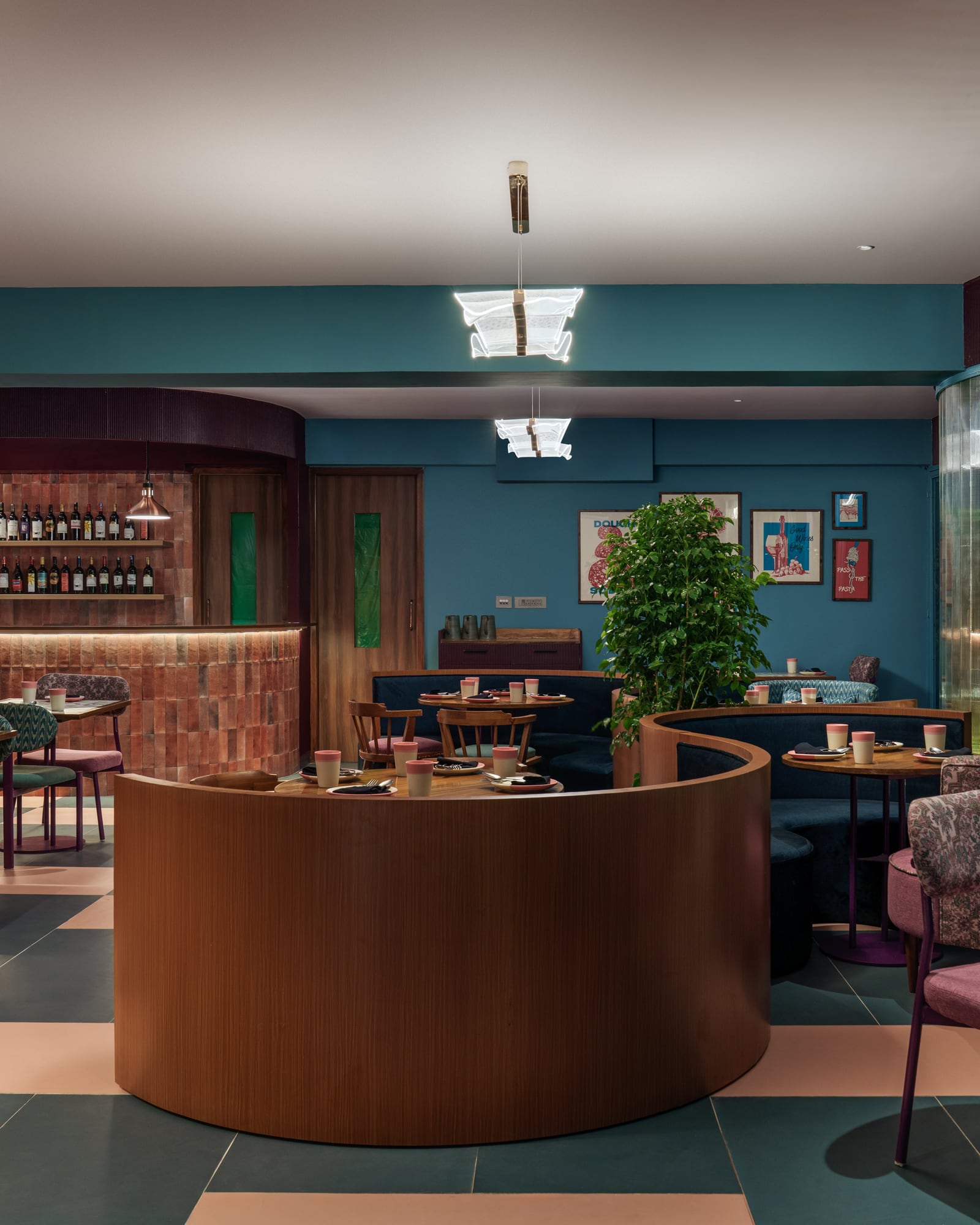The warm, teal-and-walnut dining room at Serious Slice Indiranagar
